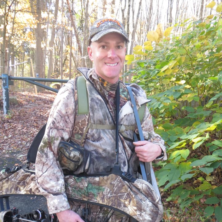 Dean Renzi in his hunting gear, with his bow and arrows.