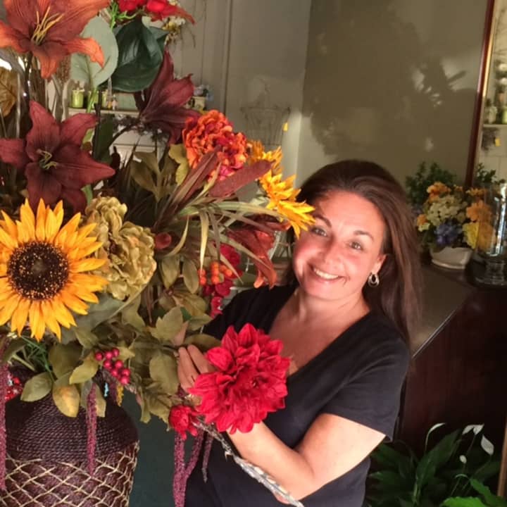 Rudy&#x27;s Flower Shop Owner Liz DeFeo poses with one of her arrangements.