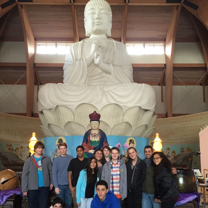 Briarcliff High School students pose with the largest Buddha statue in the Western Hemisphere at Chuang Yen Buddhist Monastery in Kent. 