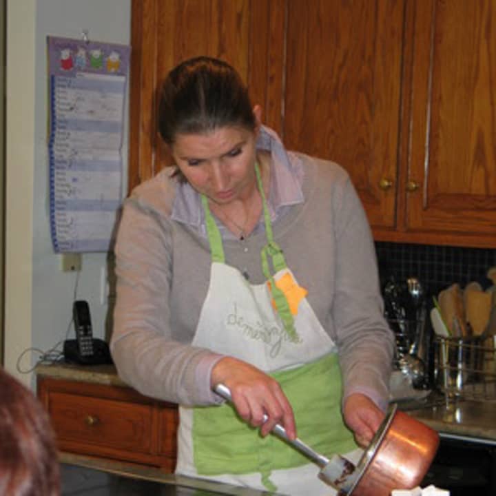 Marie-Helene Sarfas puts pot de crème into molds. 