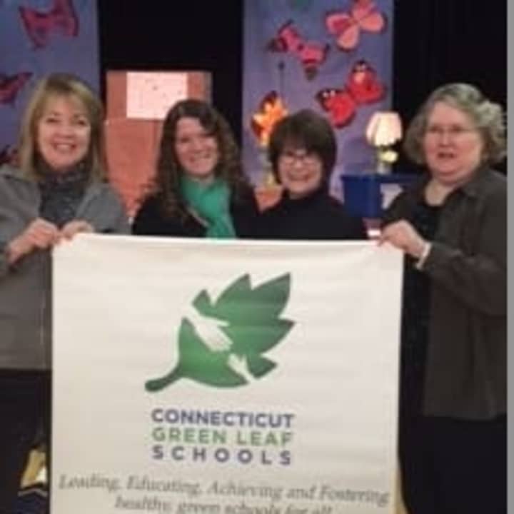 Energy Education Specialist Laurel Kohl handed Parkway School the Connecticut Green Leaf Banner at Parkways Great Green Leaf Adventure on Nov. 19.  From left, Principal Patricia Allen, teachers Rebecca Mollica and Maryjane Ackroyd and Kohl.