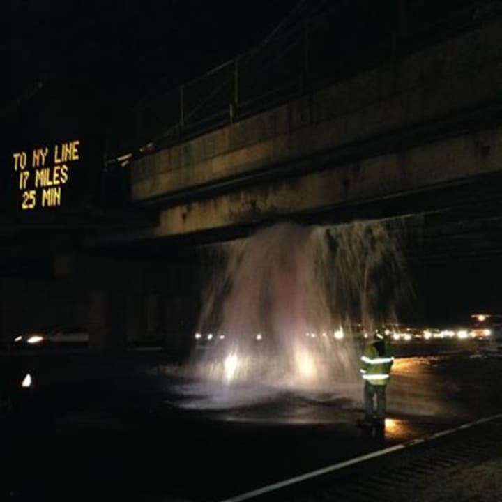 Water pours from the Strawberry Hill overpass onto I-95 after it was struck by a tractor-trailer Thursday evening. 