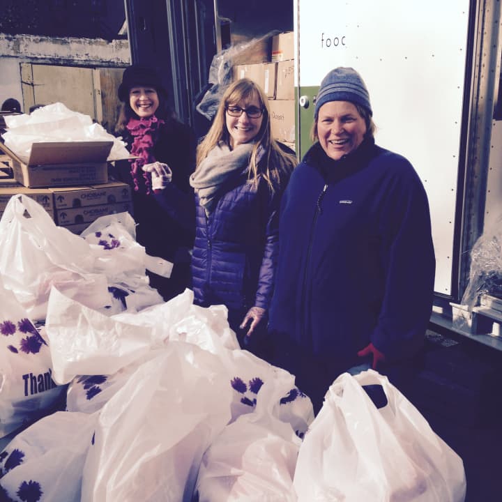 Junior League of Bronxville members Julie Latham, Elizabeth Peacock and Kathryn Hentschel help distribute turkeys to those in need at Beulah Church in Mount Vernon. 