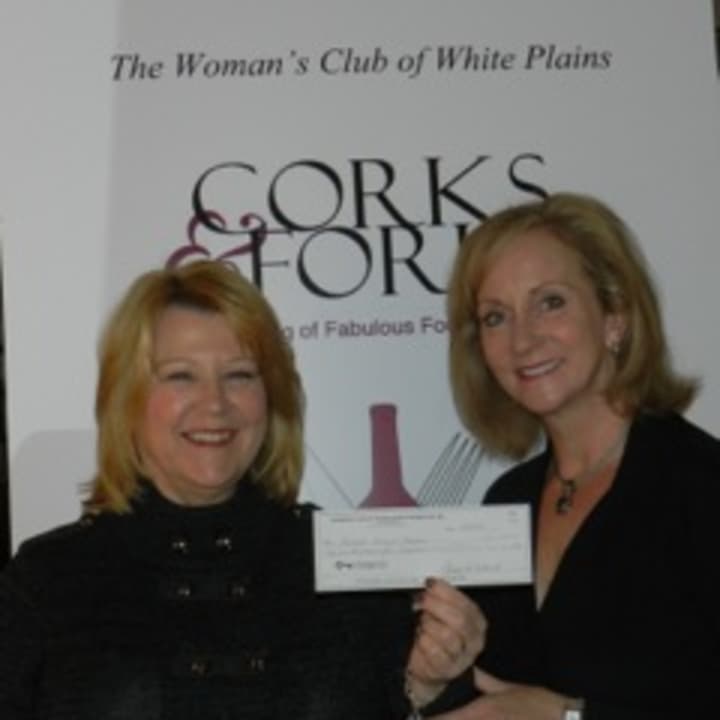 Maryann Martin, chairwoman of the Womans Club of White Plains  Corks &amp; Forks event presents Kathleen Bonistall of PEACE OUTside Campus with a check for $7,500.  
