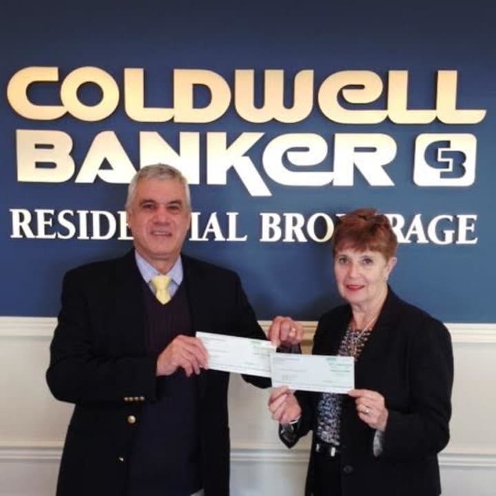 Coldwell Banker Branch Manager Martha Krakow presented checks for the 2014 CBCares Foundation contribution to Swim Across America represented by Anthony Sibio, also of Coldwell Banker Residential Brokerage. 