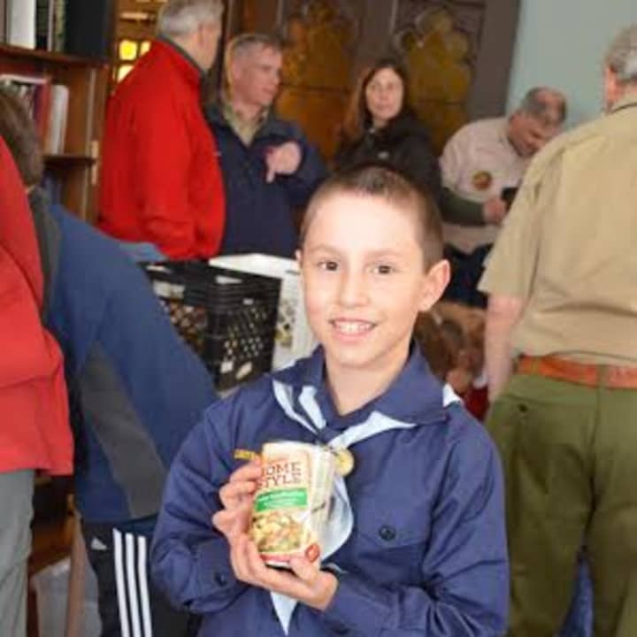 Pack 23 Cub Scout Solomon Hochman collects food at last years annual Scouting for Food drive, benefiting Neighbor to Neighbor. This years event is on Saturday, March 7.