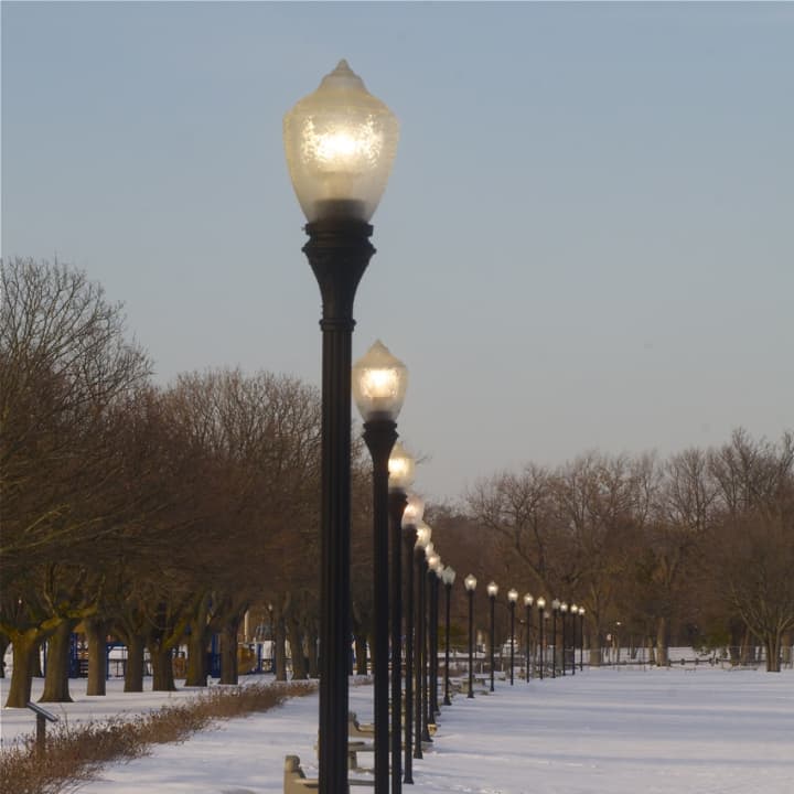 Lights come on adding to the beauty of the snow-covered beach.