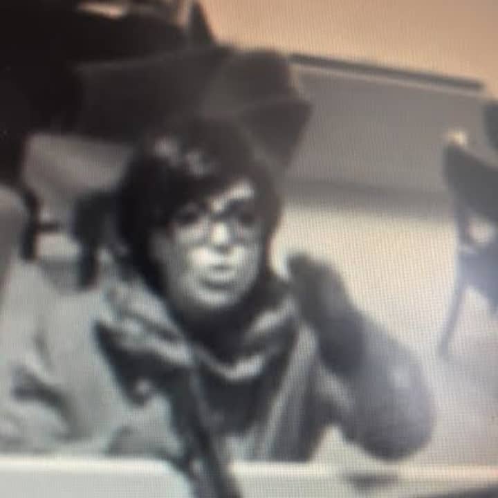 A picture of the woman robbing the Greenwich Bank &amp; Trust Company on Jan. 30. A woman has been arrested by the FBI in New Jersey in connection with a bank robbery there. Police are investigating whether the two may be linked.