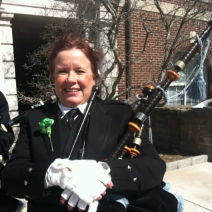Patty Sheehan holds her bagpipes before performing with the Greenwich Pipe Band at the 41st Greenwich St. Patrick&#x27;s Day parade on Sunday.
