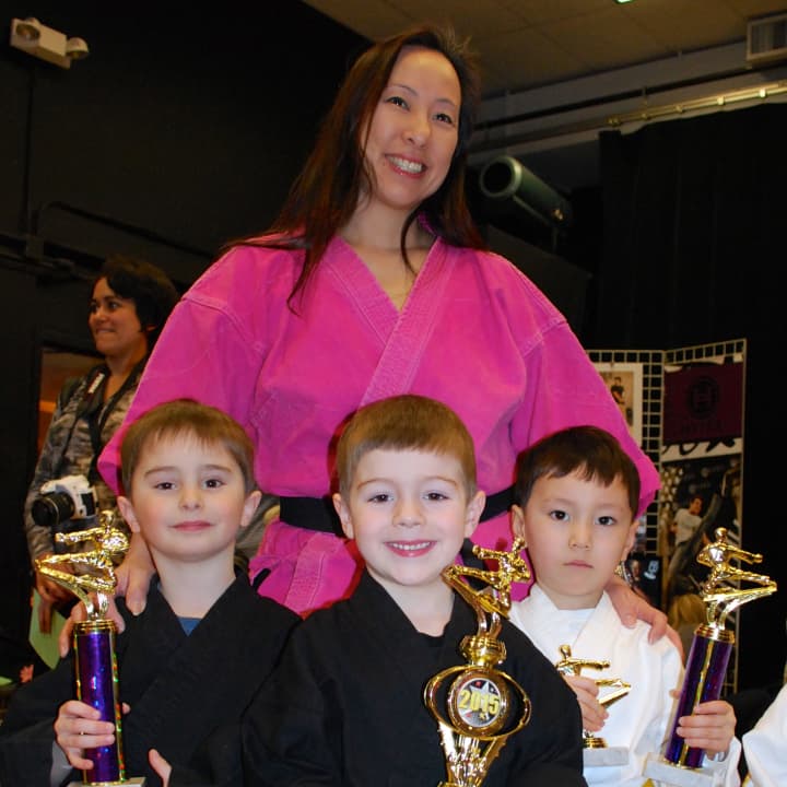 DAC Dance Director Bonnie Gombos stands with students Scott Luecke, Tyson Anavy and Rys Richards at the fourth annual Martial Arts Tournament hosted by the Darien Arts Center on Sunday, March 29. 
