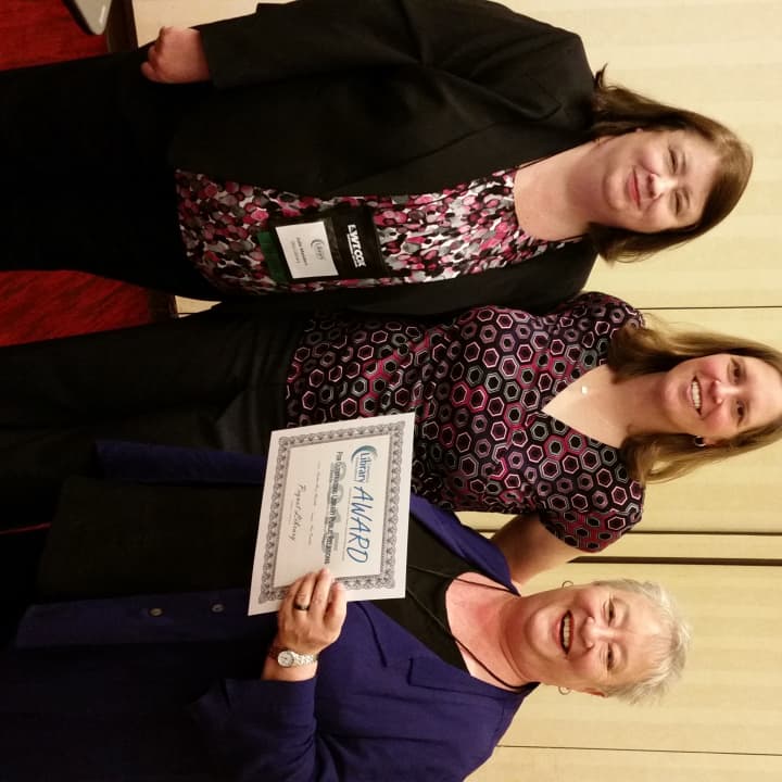 From left, Julie Menders of Otis Library and Tara Borden of East Lyme Public Library present a Connecticut Library Association publicity award to Adair Heitmann, director of communications at Southports Pequot Library. 