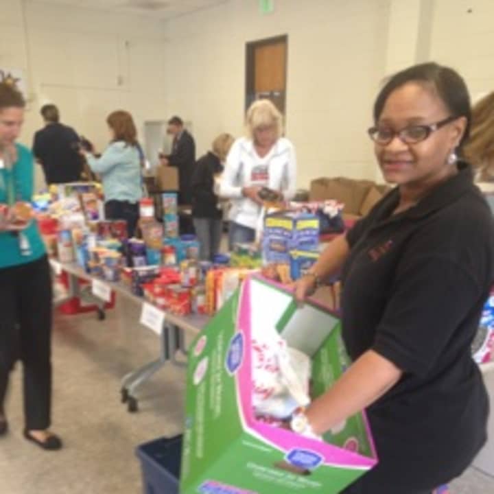 Chereese Jervis-Hill, president, Events To Remember, helps pare care packages. 