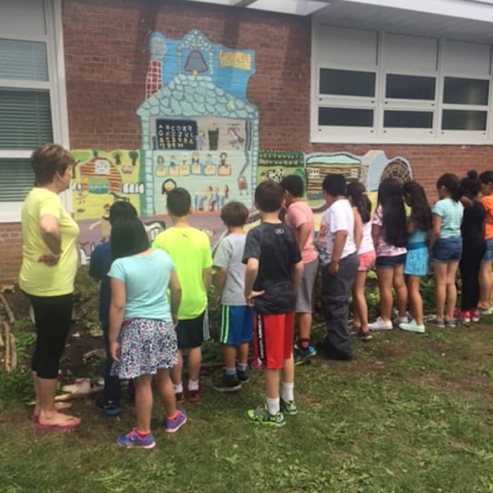 Students and parents from Claremont Elementary School recently planted a garden at the Ossining campus.