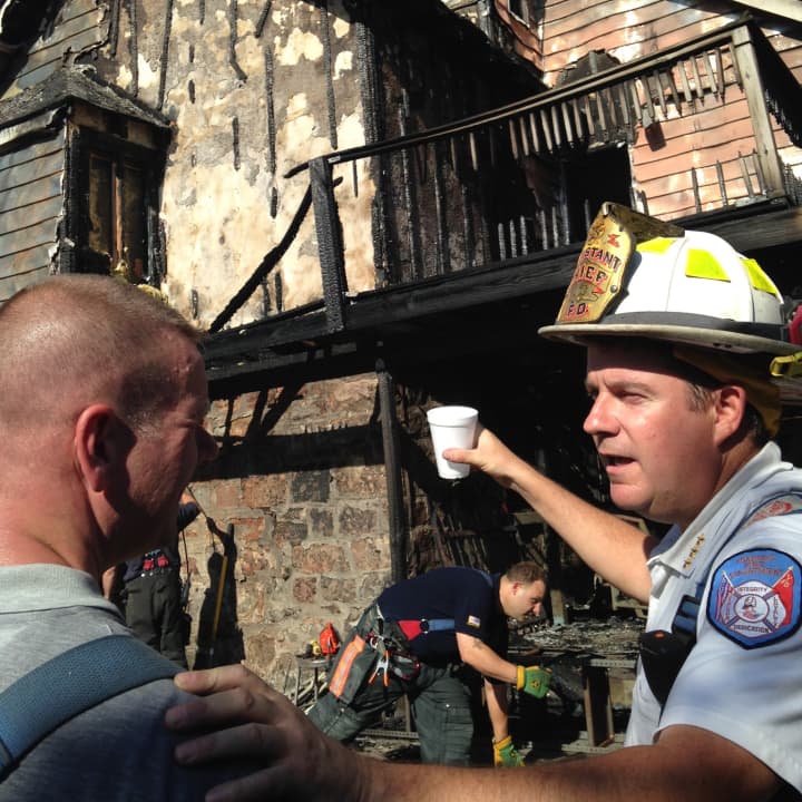 Yonkers Fire Department Lt. Christopher Thomas, left, and Assistant Chief Brian Travers at the scene of a Devoe Avenue house fire.