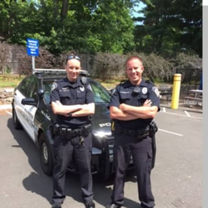 Darien police officer Greg Benedetto (right) with probationary officer Amanda Hinkley as they prepare for patrol.