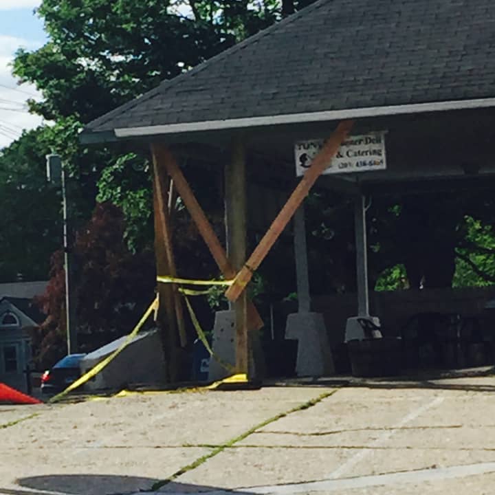 Lewisboro Police chased a woman in an allegedly stolen vehicle into Ridgefield before she crashed into Tony&#x27;s Corner Deli (pictured here Sunday with supports in place at the site of the crash).