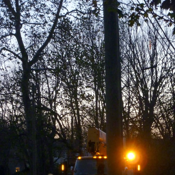 A utility truck sets up on Long Lots Road near Moss Ledge Road in Westport Monday evening. 