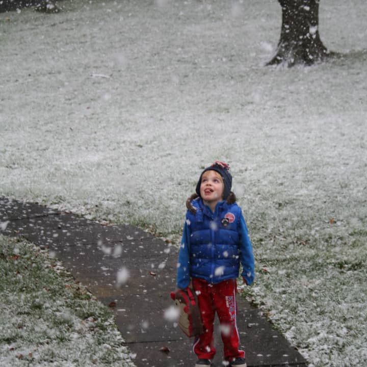 Spencer Smith of New Canaan gets a taste of the snowflakes falling Wednesday. 