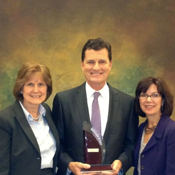 Vice President of Human Resources Jeane Costella (left) and Vice President of Administration Debbie Neuendorf (right) accept Press Ganey Success Story Award from Press Ganey CEO Patrick Ryan.  