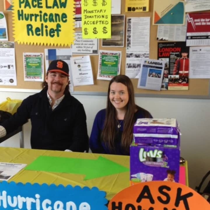 Patrick VanHall (left) and Kiera Fitzpatrick (right) collect supplies and money for Hurricane Sandy victims at Pace Law School in White Plains.
