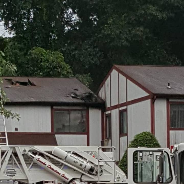 The damage from the lightning strike can be seen on the roof of this condo building at at 51 Candlelight Drive in Danbury.