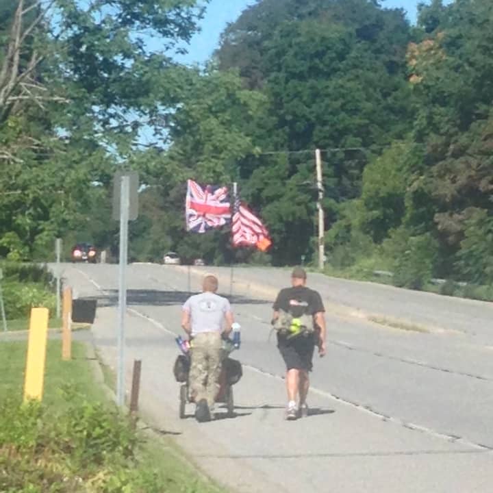 Neil Davis, right, making his way through Southeast, on Route 6, late Thursday morning.