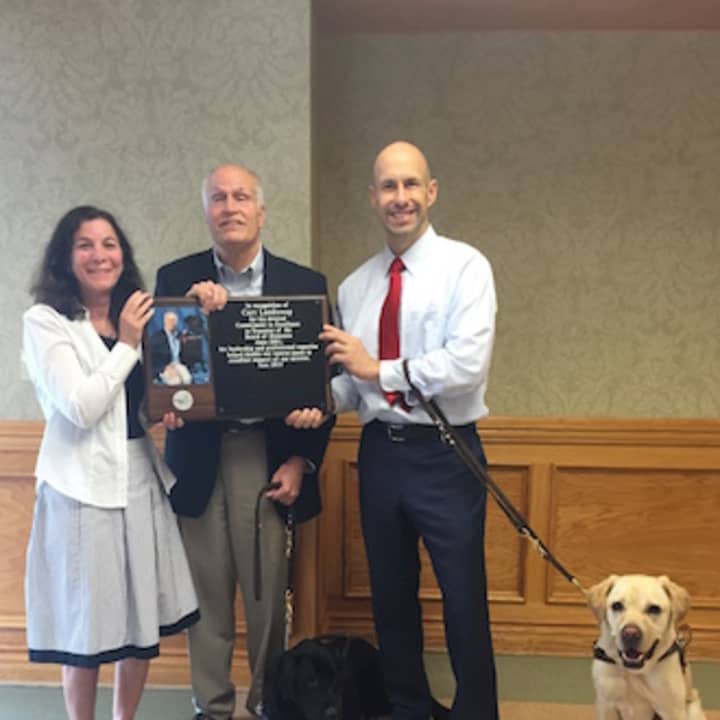 Left to right: Guiding Eyes for the Blind Board Chair Wendy Aglietti, Presidents Leadership Award recipient Curt Landtroop with his guide dog Windsor, and President and CEO Thomas Panek with his guide dog Gus.