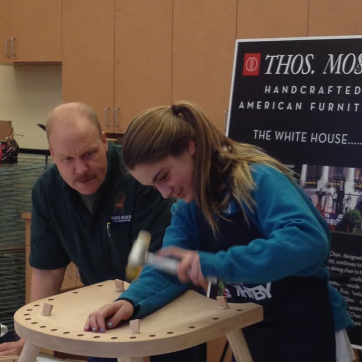 A Whitby School eighth-grader helps handcraft a rocker, under the guidance of Thos. Mosers master furniture maker Warren Shaw.