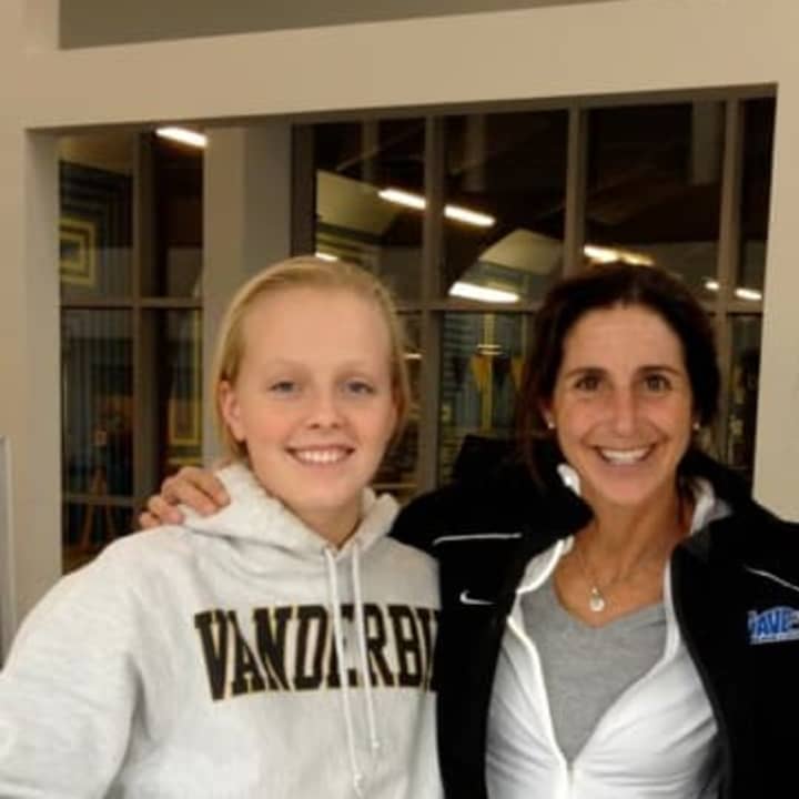 Darien swimmer Olivia Leunis, left, signs her letter of intent to attend Vanderbilt with coach Marj Trifone.