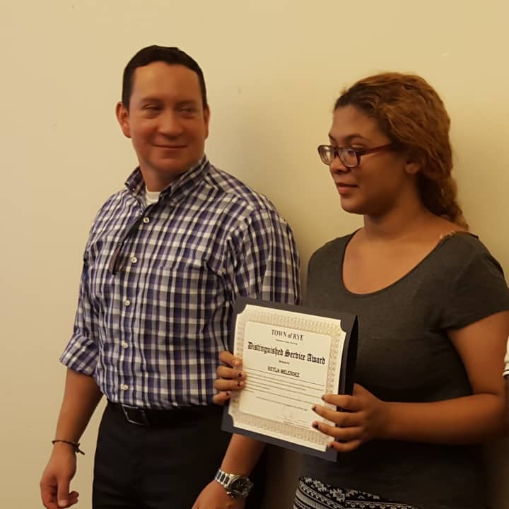 <p>Keyla Menendez receives her award for completing the town of Rye internship program from Alex Payan, a consultant with the town. Menendez interned with Carol Nielsen at the Port Chester Senior Community Center. </p>