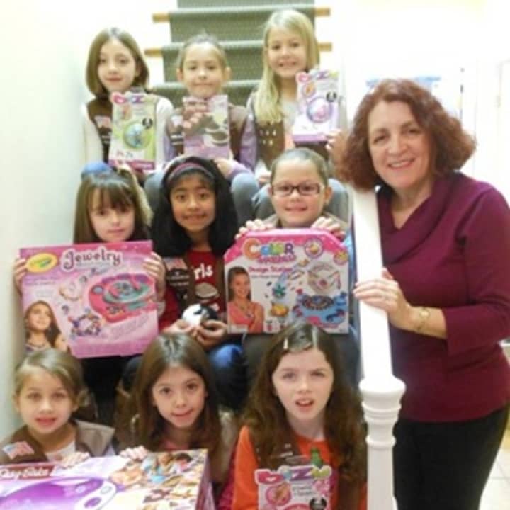 Denise Tredwell, coordinator of Friends of Karen Adopt a Family Toy Drive, and the members of North Salem Brownie Troop 1144 who brought in their donations