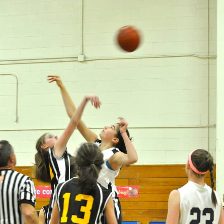 Virginia Gerig of the Westport PAL eighth-grade girls basketball team, left, tips off against Redding-Easton.