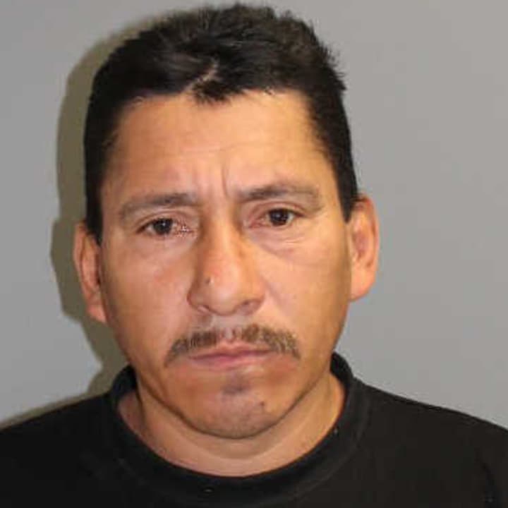 Carlos Linares of Norwalk was charged with hitting another man with an ice scraper, police said.