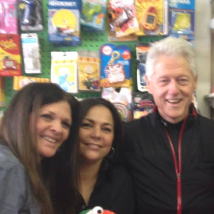 Auntie Penny owners Eve Spence, left, and Linda DeMase stand with former President Bill Clinton. Clinton, a Chappaqua resident, stopped in their store to do some last-minute shopping on Christmas Eve.