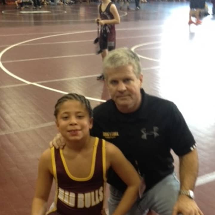 Norwalk Mad Bull wrestler Koy Price, shown with coach Art Schad, is undefeated this season. 