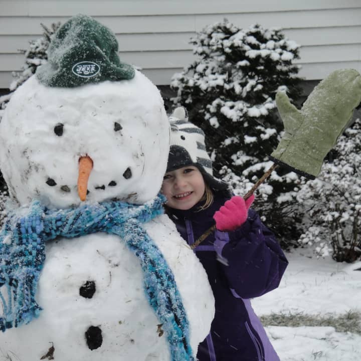 Kate Richardson, 5, with a snowman she made in Rye/Port Chester.