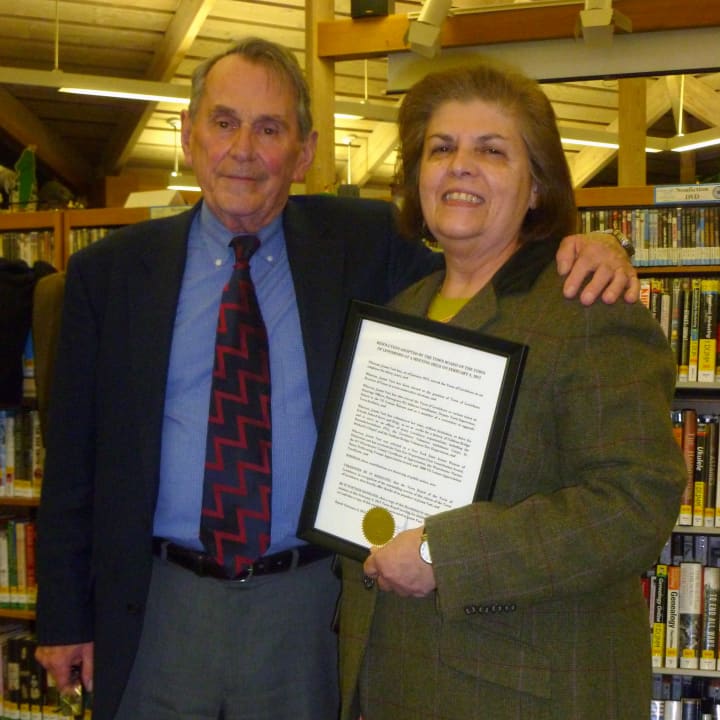 Supervisor Peter Parsons presents Joann Vasi, the town&#x27;s receiver of taxes, a congratulatory proclamation for 30 years of service. 
