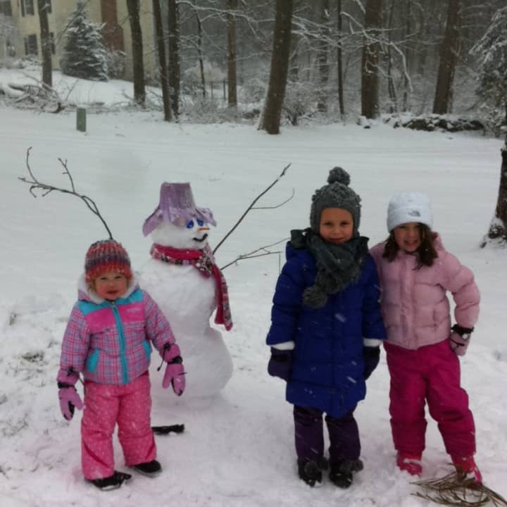 Sisters Eliana and Madelyn Soccio, 5 and 2 respectively, built a snowman along with friend Riley Stewart, 5, outside the Soccio residence on Arrowhead Trail. 