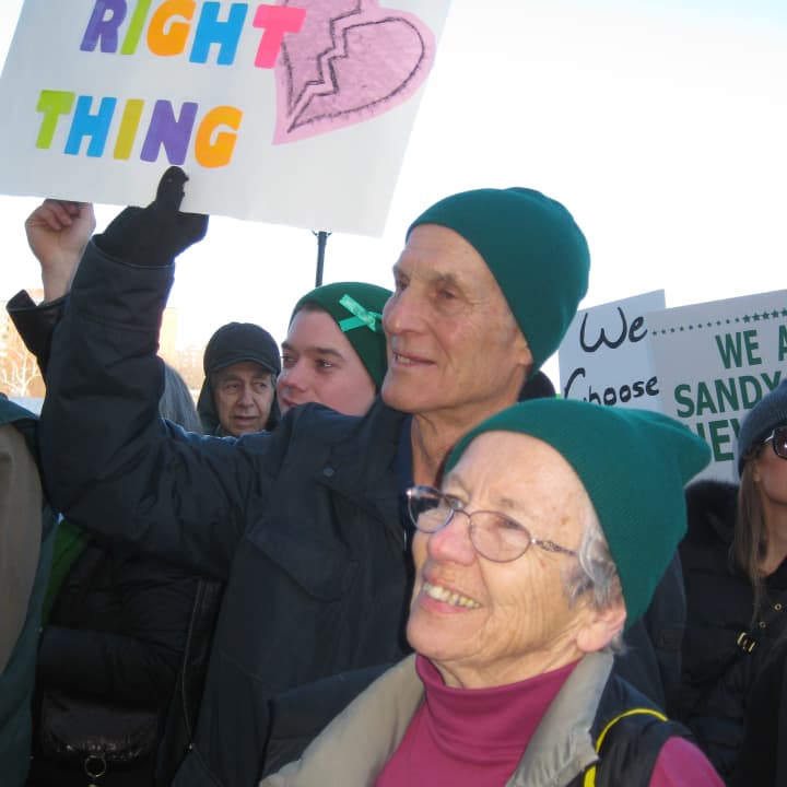 Bob and Lynn Taborsak of Danbury take part in the March For Change rally Thursday in Hartford. Lynn made the sign Bob is holding. 