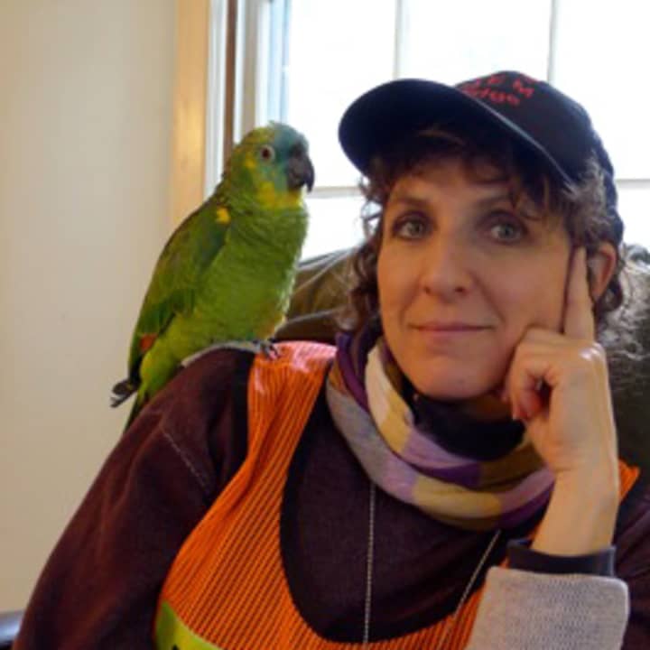 Pound Ridge artist Donna Simons poses in her emergency vest with her parrot Sweet Pea at the Town House after Hurricane Sandy.