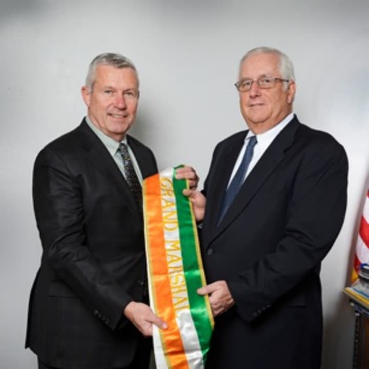 White Plains City Council Member John Martin (left) presents the grand marshal&#x27;s sash to Mike Daly.