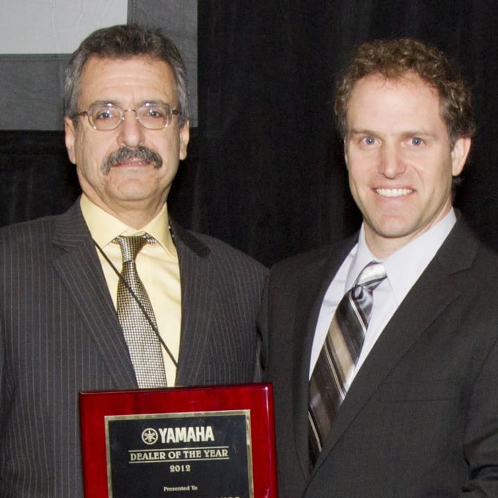 Sam Varon (left) and Josh Faust accept the &quot;Acoustic Dealer of the Year&quot; award from Yamaha.