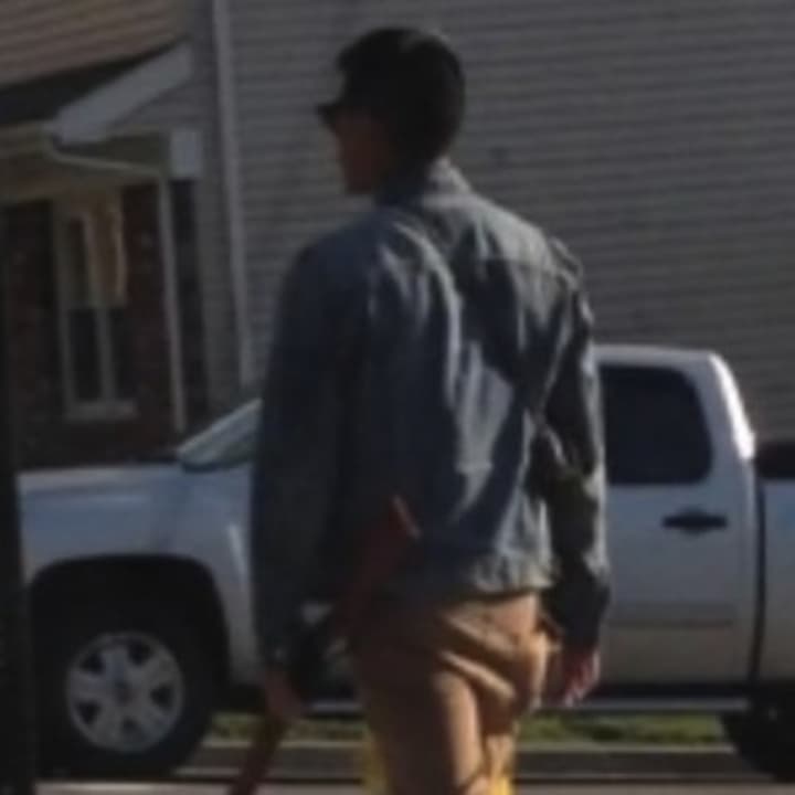This man was seen carrying what appears to be a lever action rifle on Underhill Avenue in West Harrison Saturday. Police are asking for help identifying him.