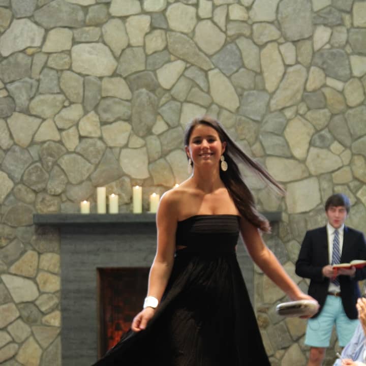 Annabel Holland of Rowayton hits the St. Luke&#x27;s runway. Jackson Prince of New Canaan, co-Master of Ceremonies, is in background.