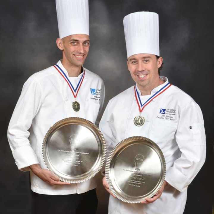 Jason Nyman, Manager of Food &amp; Nutrition of Patient Services (left), and John Graziano, Manager, Executive Chef, (right) with Silver Plate awards for their winning dish at the 2016 Association for Healthcare Foodservice Culinary Competition.