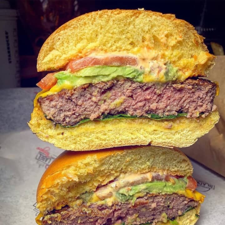 Black Label burger with American cheese, lettuce, tomato, onion and label sauce (avocado added) from Black Label Burgers, located at 683 Old Country Road in Westbury