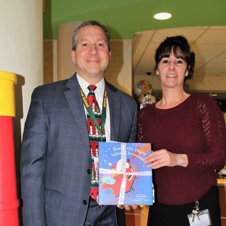 Principal Gary Mastrangelo poses with Debbie Sicari, Blythedale&#x27;s coordinator of therapeutic recreation after dropping off pajamas donated by Greenburgh&#x27;s Highview Elementary School .