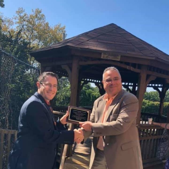 Doug DiPaola, right, receives an award from Paramus Home for Veterans CEO Matthew Schottlander after fixing the gazebo and building the ramp last summer.
