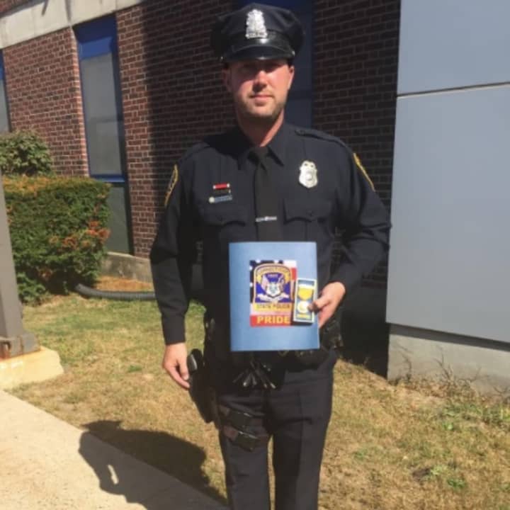 Norwalk Officer Dave Peterson was honored for providing aid during a serious motor vehicle accident.