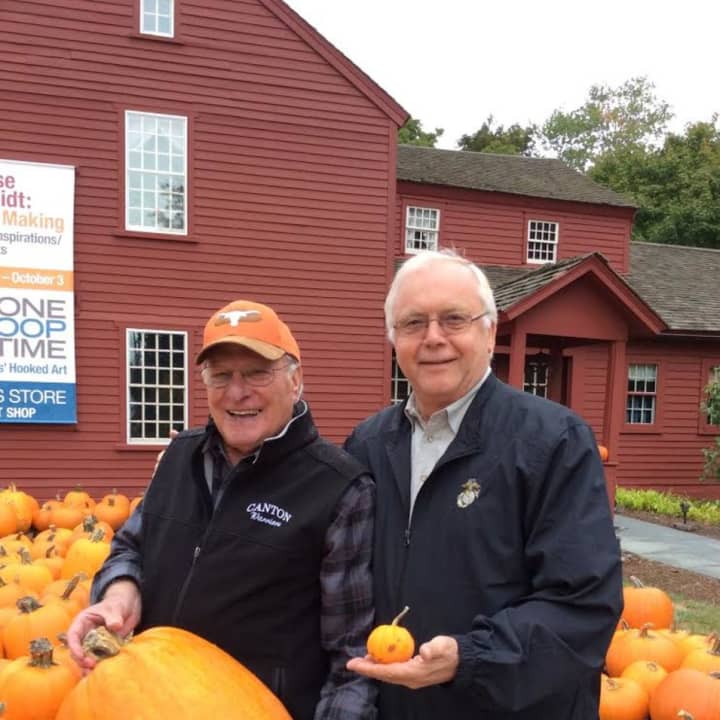Wilton Kiwanis members Dave Forslund, left, and Raymond Tobiassen show off the range of pumpkin sizes available at the sale. 